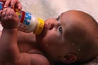 Fotografía de un bebé comer solo una botella